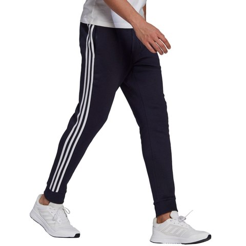 Spodnie męskie adidas Essentials Fleece Tapered Cuff 3-Band Pants granatowe GK8823 S Adidas