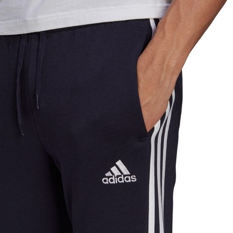 Spodnie męskie adidas Essentials Fleece Tapered Cuff 3-Band Pants granatowe GK8823 S Adidas