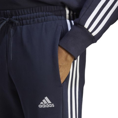 Spodnie męskie adidas Essentials French Terry Tapered Cuff 3-Stripes granatowe IC9406 Adidas Spodnie męskie adidas Essentials French Terry Tapered Cuff 3-Stripes granatowe IC9406 Adidas