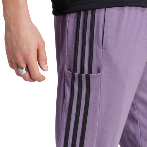 Spodnie męskie adidas Essentials Single Jersey Tapered Open Hem 3-Stripes fioletowe IJ8699 M Adidas